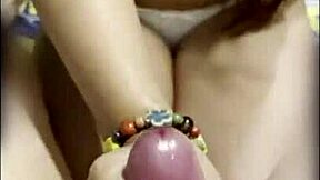 Pretty Asian teen gives her boyfriend a great handjob