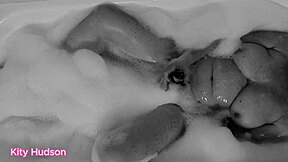 Kitty Hudson in the tub with a toy