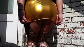 Gold dress adventure unfolds as Australian ladyboy princess dominates British mistress in a daring scene. Her bold moves captivate all.