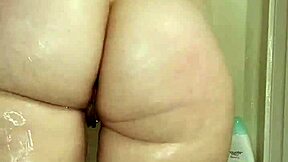 Shaved head pawg gets her tits and ass wet in the shower