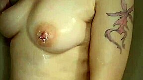 Shaved head pawg gets her tits and ass wet in the shower