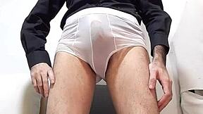 Cocky crossdresser shows off huge cock in see-through underwear