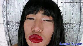 Long-haired Russian shemale enjoys anal play with dildo