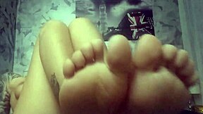 Foot fetish camgirl teases with cute face and small tits