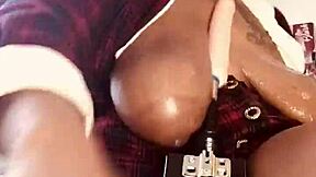 A voluptuous woman with large breasts gets pleasure from a sex machine