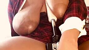 A voluptuous woman with large breasts gets pleasure from a sex machine