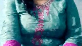 A young Indian woman overcomes her dissatisfaction by pleasuring herself on camera, revealing her large breasts and attractive physique.