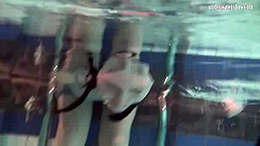 Russian teen Katya Okuneva flaunts her bouncing breasts in a poolside dress