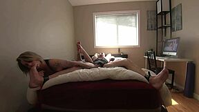 Wife teases her restrained husband's sensitive feet and genitals in a two-part series