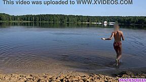 Bare-naked woman takes a dip at a public beach