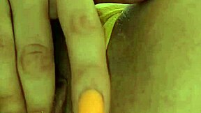 A young woman pleasures herself with a lollipop and fondles her backside in a homemade video