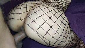 Brunette model entices boss with alluring fishnet bodysuit