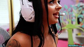 Payton Preslee, a busty gamer girl, gives oral pleasure to Tommy Gunn's erect penis