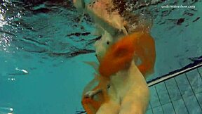 Nastya undresses and exposes her attractive bare body in the swimming pool