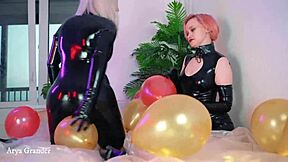 Two hot lesbians in tight rubber catsuits play with balloons for kinky fun