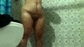 Watching my mature stepmom's big tits and ass in the shower