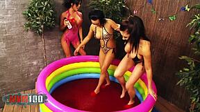Three girls in pool having lesbian sex with ketchup