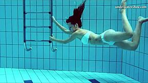 European beauty shows off her shaved pussy in pool