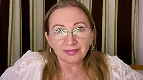 Seductive mature woman Mariaold provocatively flaunts her ample bosom in alluring undergarments and hosiery