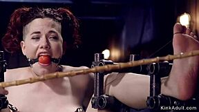 Redhead endures custom BDSM device bondage and gas mask choking
