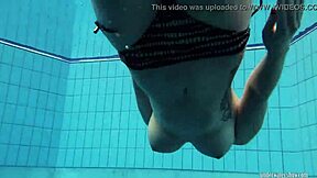 Red-haired amateur, Katrin, strips underwater during a swim workout.