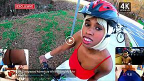 A black girl rides a bicycle in public while exposing her buttocks.