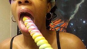 A black beauty enjoys sucking a lollipop shaped like a unicorn
