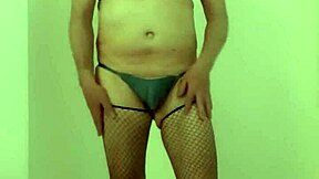 Sissy Peckey in fishnet stockings with a sex toy inside her vagina