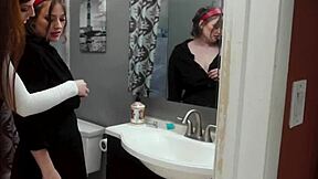 Redhead and brunette teens in hot lesbian bathroom action