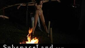 A BDSM scene with a female submissive who is flogged while she is carrying heavy weights