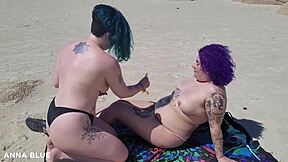 Two women kiss on the beach in Florianopolis, Brazil and show their asses