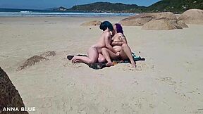 Two women kiss on the beach in Florianopolis, Brazil and show their asses