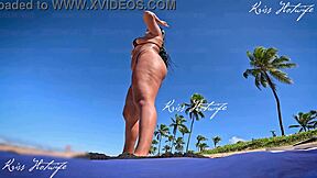 Tanned beauty flaunts big tits and ass on beach