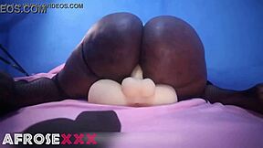 Black beauty enjoys solo pleasure with a male torso sex toy