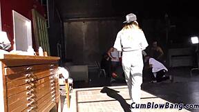 A tattooed woman gives a blow job and sucks black dicks in a gang bang scene