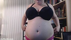 Big boobs and a big belly, eating a lot of tiramisu