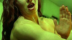 Red-haired woman with large chest muscles posing in front of the mirror