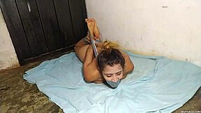 Hysterical Latina slut hogtied naked in dark basement.