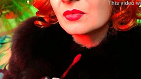 Arya Grander is a fetish goddess with red lips and leather outfit