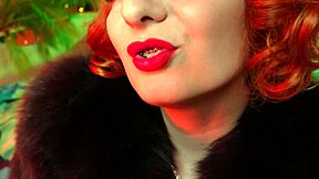 Arya Grander is a fetish goddess with red lips and leather outfit