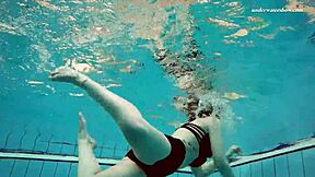 Young European woman goes for a swim in the pool