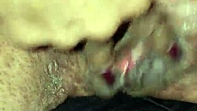 Wet granny fingers her pussy in a parking lot with strangers watching. Black car nearby adds thrill.