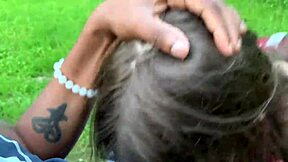 Beautiful brunette with blue eyes sucks big black cock in the park