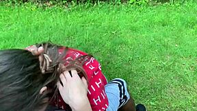 Beautiful brunette with blue eyes sucks big black cock in the park