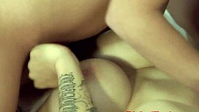 A busty beauty enjoys a facial and licks her lover’s cum from her wet pussy in a threesome adult film