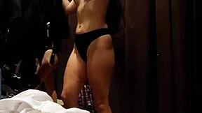 A beautiful girl enjoys pleasuring herself in the fitting room