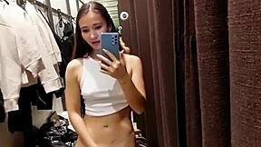 A beautiful girl enjoys pleasuring herself in the fitting room