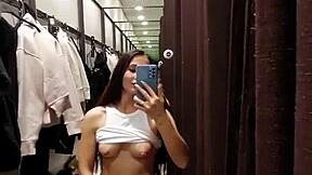 A beautiful girl enjoys pleasuring herself in the fitting room