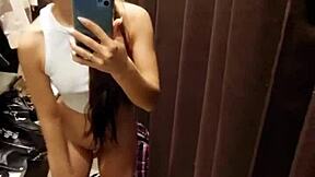 A beautiful girl enjoys pleasuring herself in the fitting room