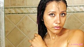A shy brunette with large hair takes a shower and gets more than she bargained for
